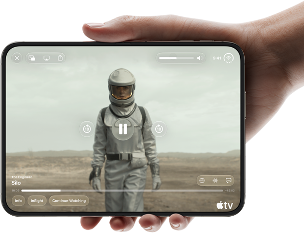 iPhone Duo, held with one hand, opened in horizontal orientation, fully unfolded, interior screen displays Apple TV show