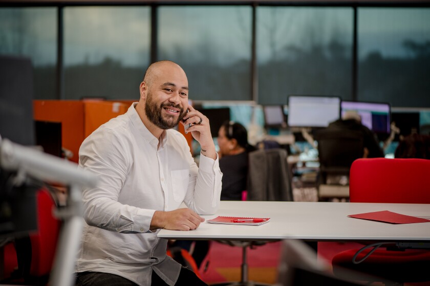 Happy person talking on a phone in an office environment.