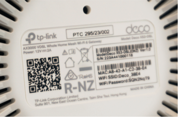 Base of a deco X53 modem showing WiFi login details