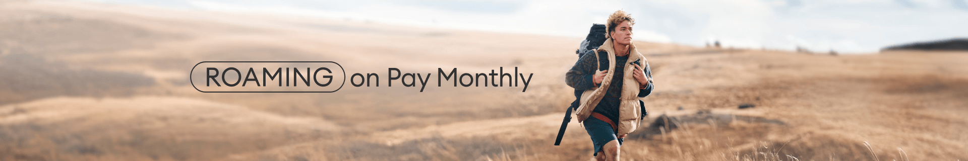 Jade walking down a grassy hill with a backpack.