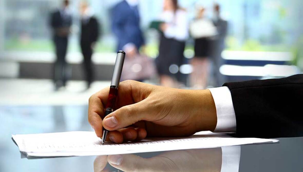 Person signing a legal document.