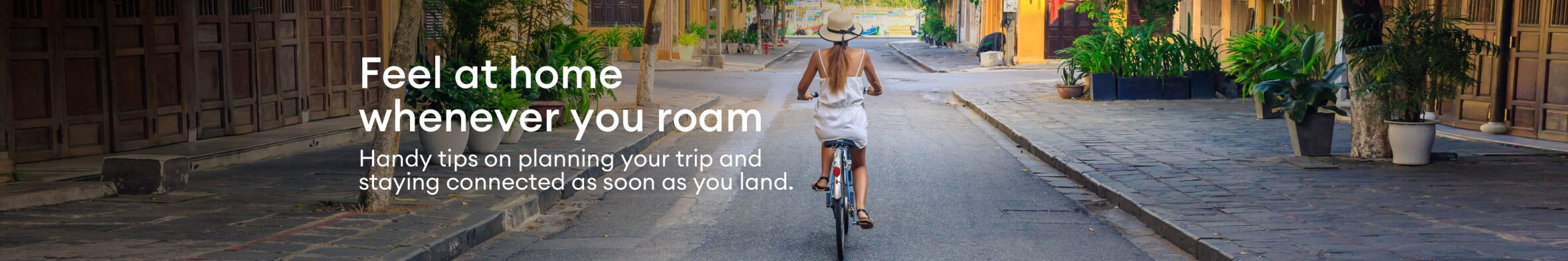 A lady, biking cobbled tropical streets, while roaming.