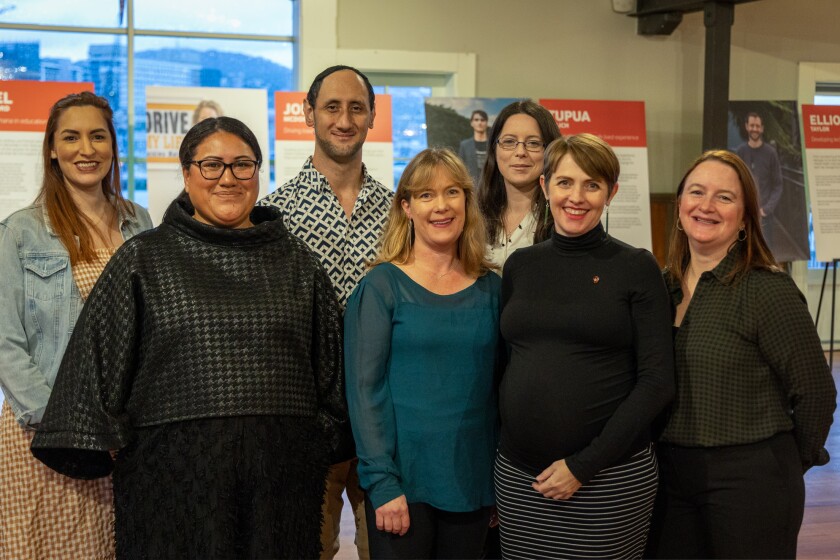 Employees of the Vodafone Foundation standing and smiling at the launch event for the 20th celebration