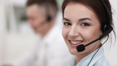 Woman in a call centre wearing headset with mic