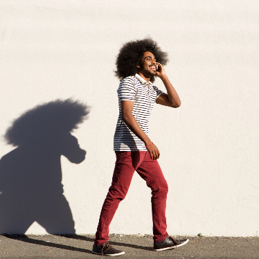 man walking and talking on mobile phone