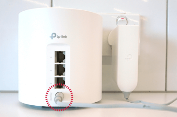 Power adapter plugged into Deco X50-DSL modem.