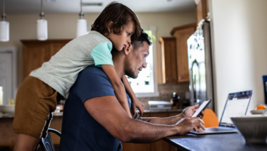 Father and son on the laptop in the kitchen