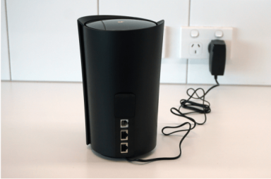 Power cable and adapter plugged into Dexo X80-5G modem.