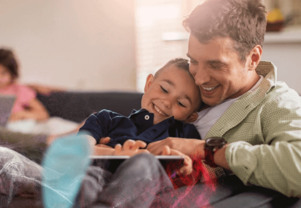 Father and son using a digital tablet and smiling