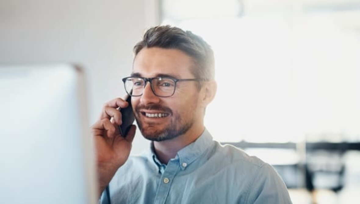 Man talking on phone in office