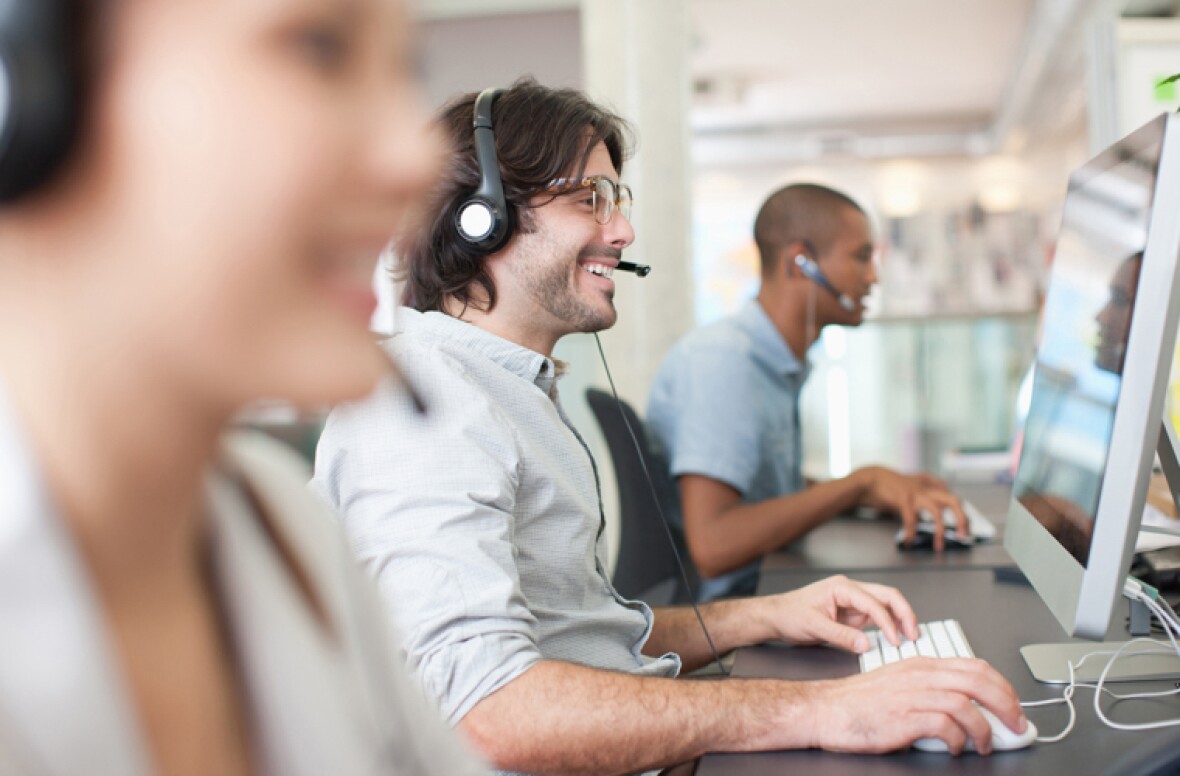 Man talking on a headset in a call centre