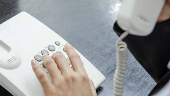 Traditional home phone being dialed