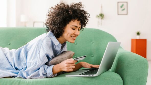 A smiling woman purchasing through our online store.