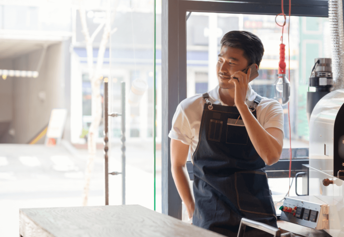 Person working in barista talking on the phone