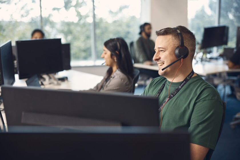 Call centre staff in a brightly lit office.