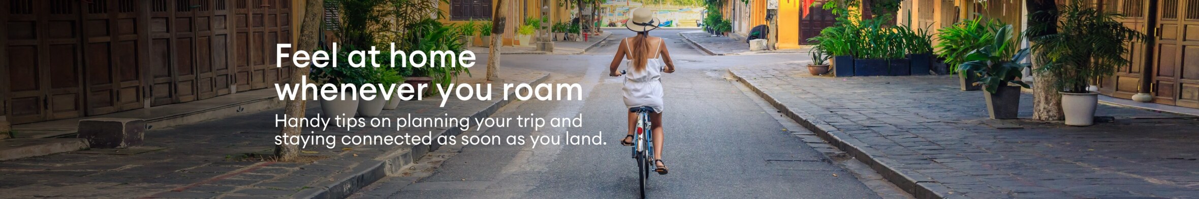 A lady, biking cobbled tropical streets, while roaming.