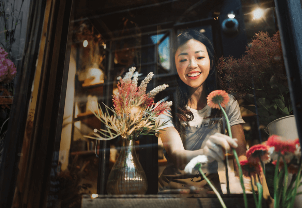 smiling florist working at her shop