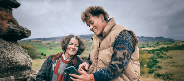 Scottish Mum and Jade on Stone Wall with a phone