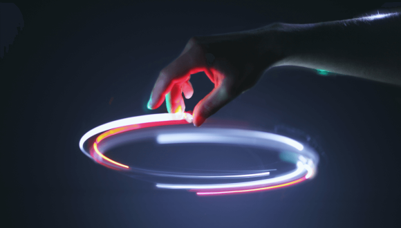 hand on top of a circle of colourful lights