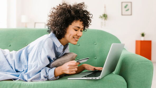 A smiling woman purchasing through our online store.