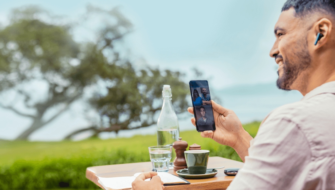 Man on a video call on his phone in a garden