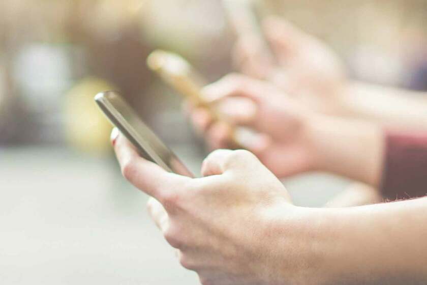 A line of people, all using unlimited data on their phones.