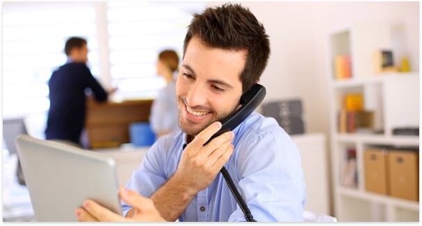 Guy on a call in the office viewing content on tablet