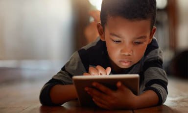 A young child using his iPad over WiFi.