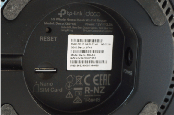 Base of a deco X80-5G modem showing WiFi login details