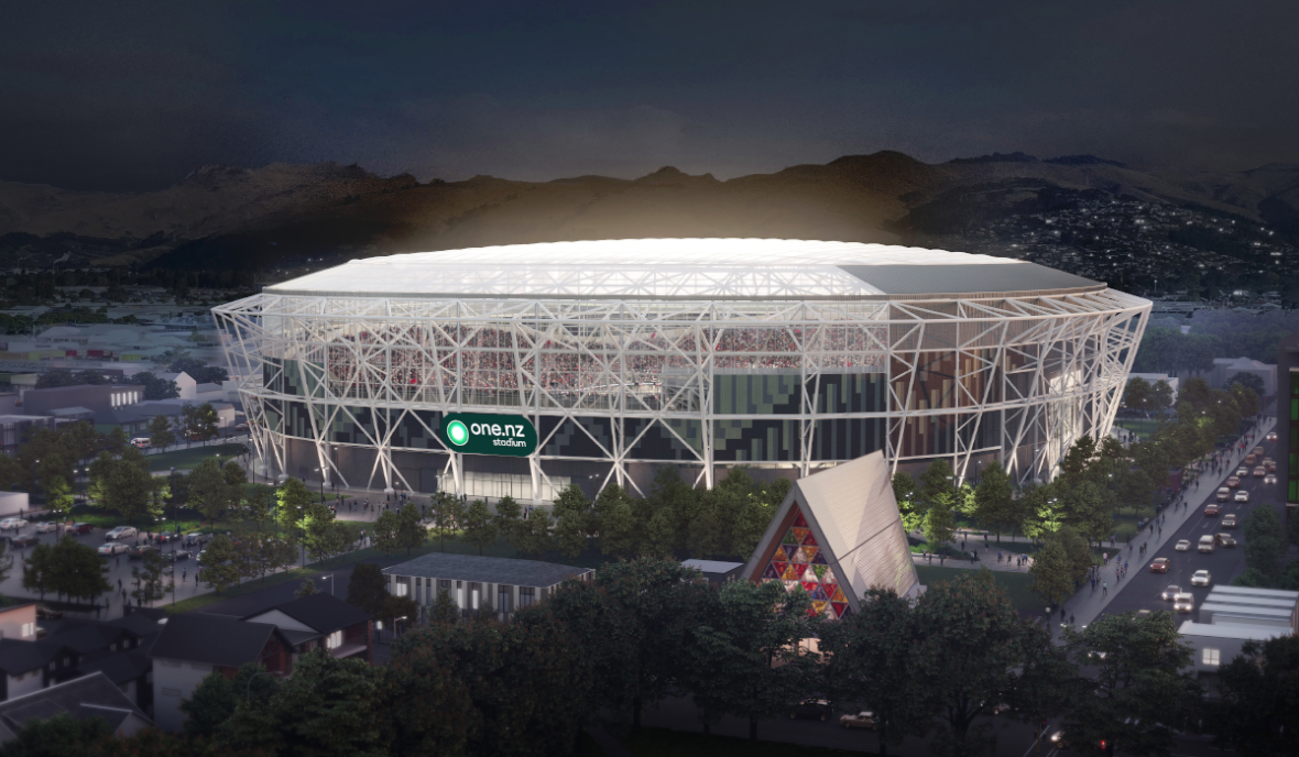 Large illuminated stadium at night with “one.nz stadium” signage, surrounded by trees and city buildings.