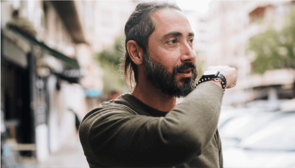 A man using his OneNumber for a phone call, over his watch.