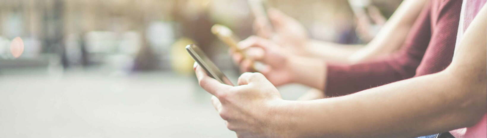 A line of people, all using unlimited data on their phones.