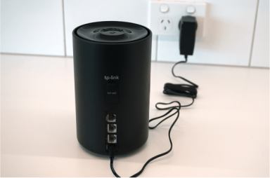 Power cable and adapter plugged into Dexo X58-4G modem.