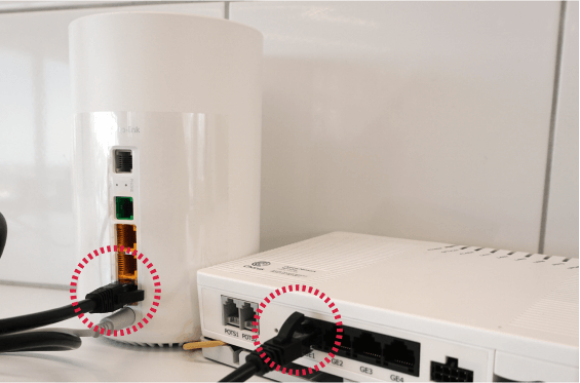 Network cable plugged into Deco X53 DSL modem and ONT fibre box