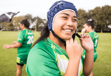A rugby girl athlete using her headguard