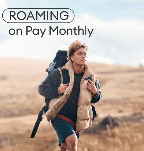 Jade walking down a grassy hill with a backpack