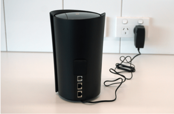 Power cable and adapter plugged into Dexo X80-5G modem.