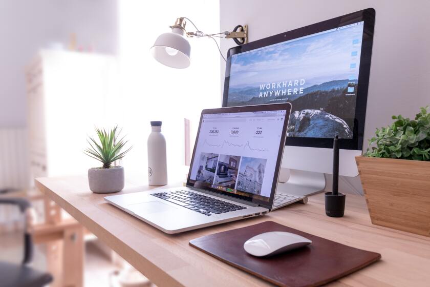 Laptop and desktop on desktop workspace | Photo by Domenico Loia on Unsplash.